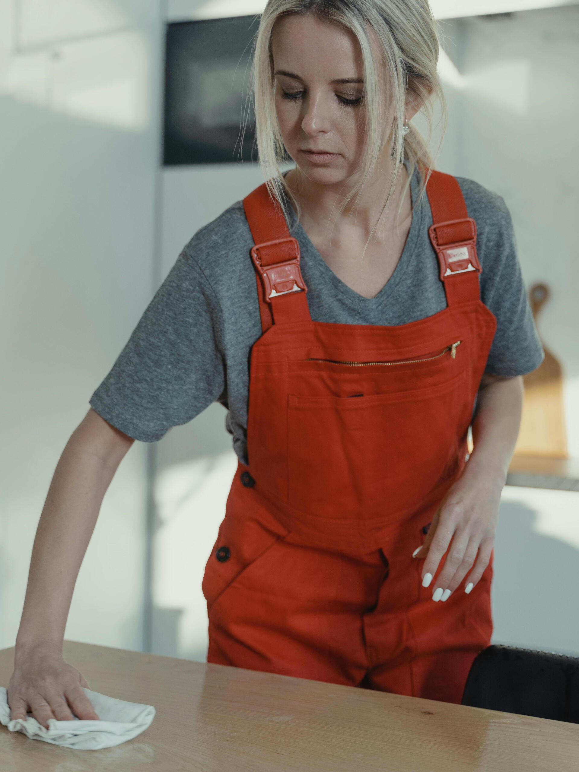 Küchenoberflächenreinigung – Karl & Olaf Reinigungskraft wischt Küchenoberfläche während Hausreinigung